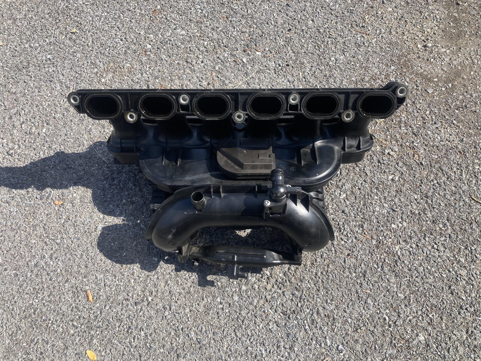 BMW N52 intake manifold underside, six runner ports visible